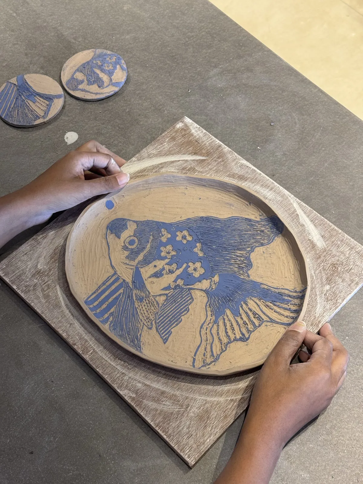 A large sgraffito platter, a fish carved through blue slip to bare clay