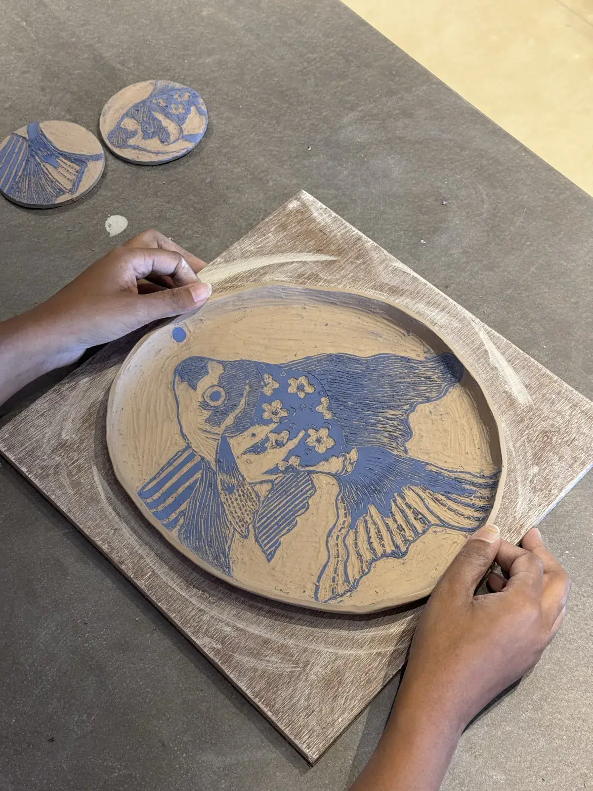 A large sgraffito platter, a fish carved through blue slip to bare clay